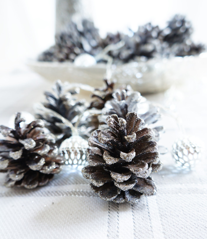 Sparkly Pinecones on a white tablecloth
