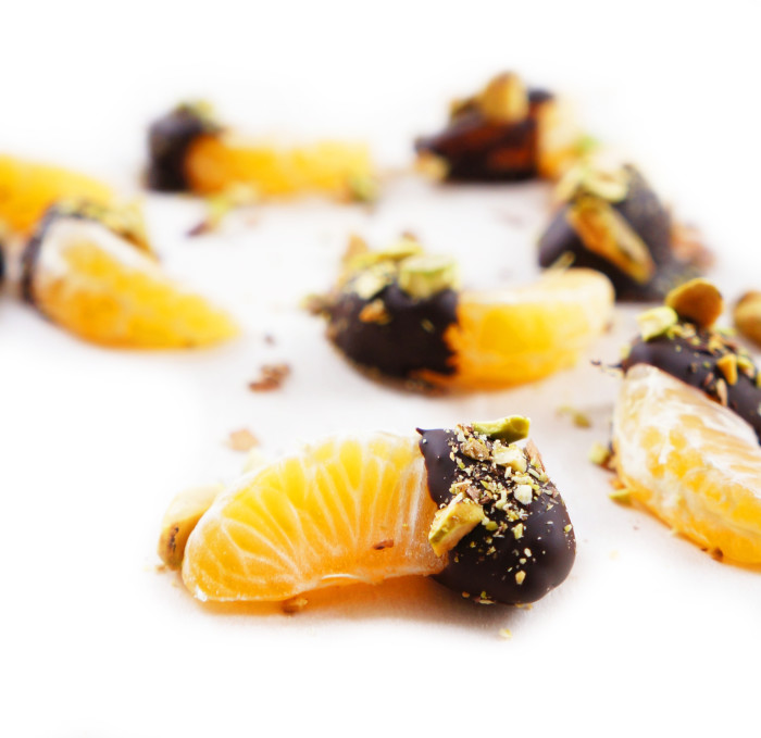 Closeup of Chocolate Dipped Clementines with Chopped Pistachios