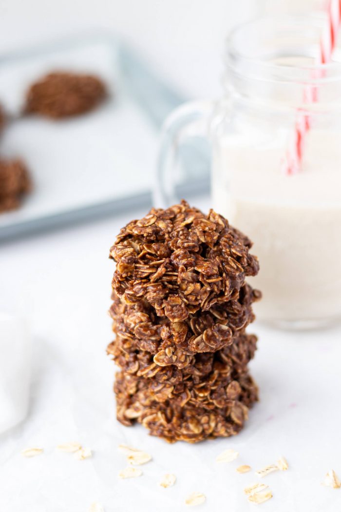 Stack of No-Bake Flourless Chocolate Cookies in front of a jar of milk