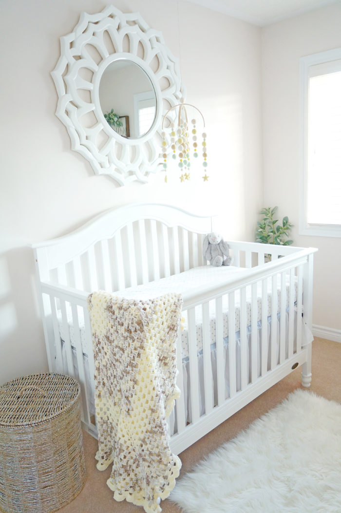 A beautiful white crib in a gender neutral baby nursery
