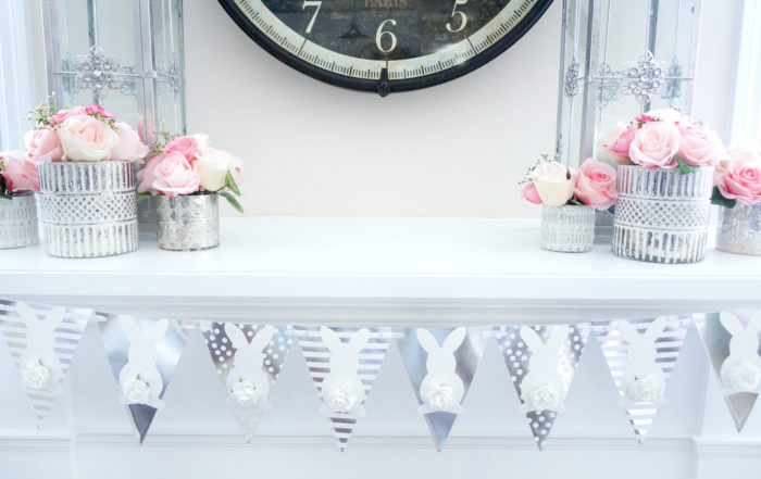 Silvery bunny banner on a white mantle under a large clock