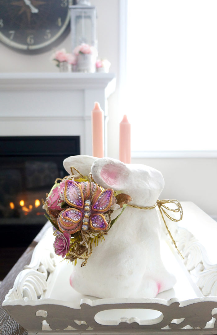 Pretty Easter bunny and pink flowers on fireplace mantel for Spring living room decoration