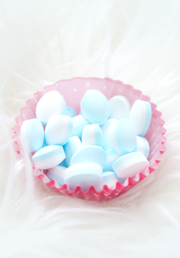 Pink paper muffin tin filled with blue mints