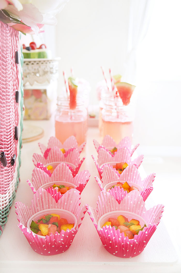 Bright pink paper muffin tins filled with fruit cups