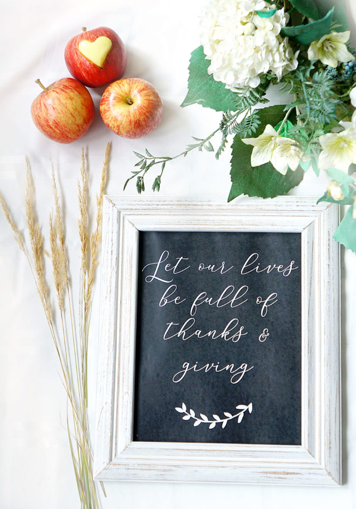 Framed paper that says \"Let our lives be full of thanks & giving\" in script