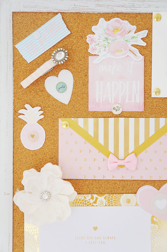 Part of a cork board filled with pastel papers and decorations
