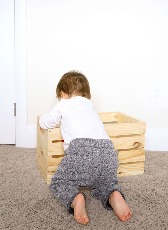 Baby reaching in to a Wooden Crate
