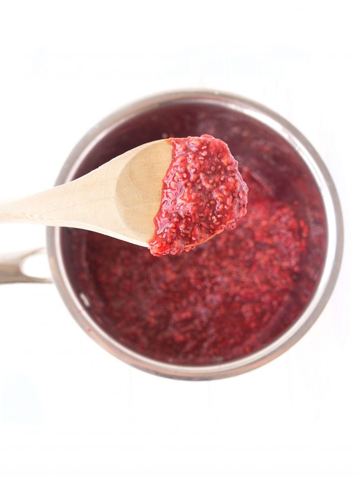 Wooden spoon covered in raspberry chia seed jam