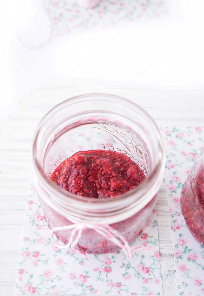 Mason jar with raspberry chia seed jam on the bottom