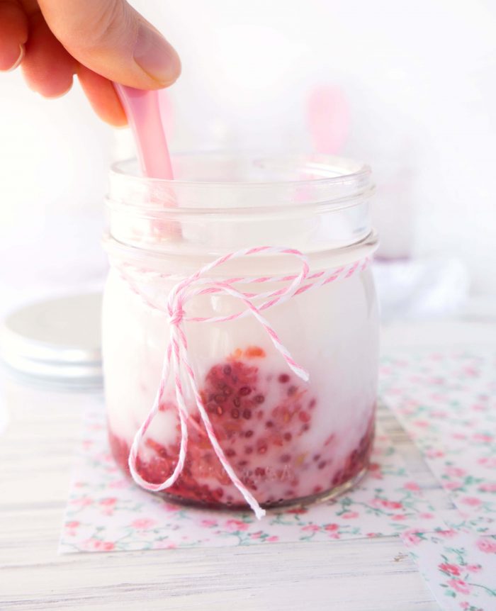 Spoon stirring a Homemade Raspberry Fruit-on-the-Bottom Yogurt Mason Jar