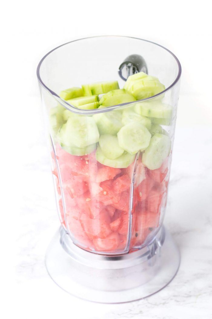 Blender with pieces of watermelon and cucumber