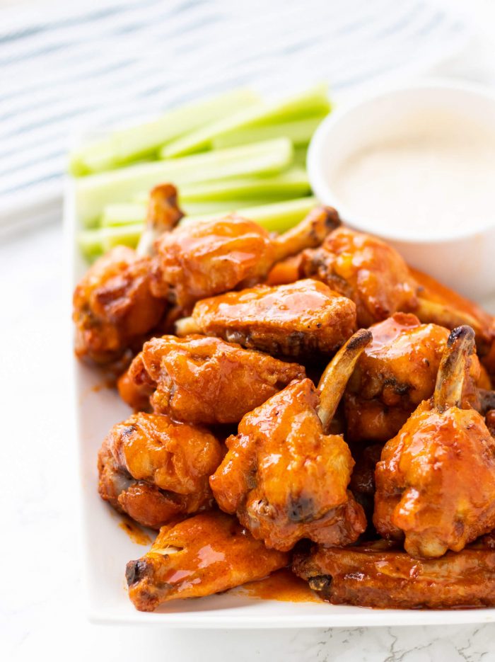 Crispy Baked Buffalo Chicken Wings on a plate with celery and dip