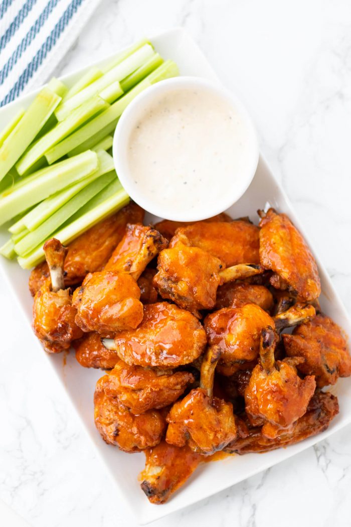 Crispy Baked Buffalo Chicken Wings with celery and dip