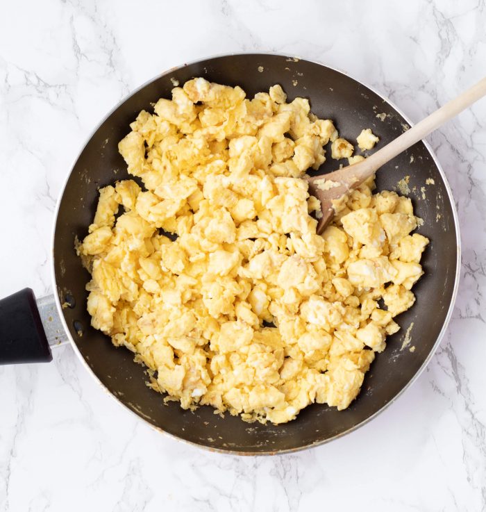 Scrambled eggs for Healthy Breakfast Burritos in a skillet