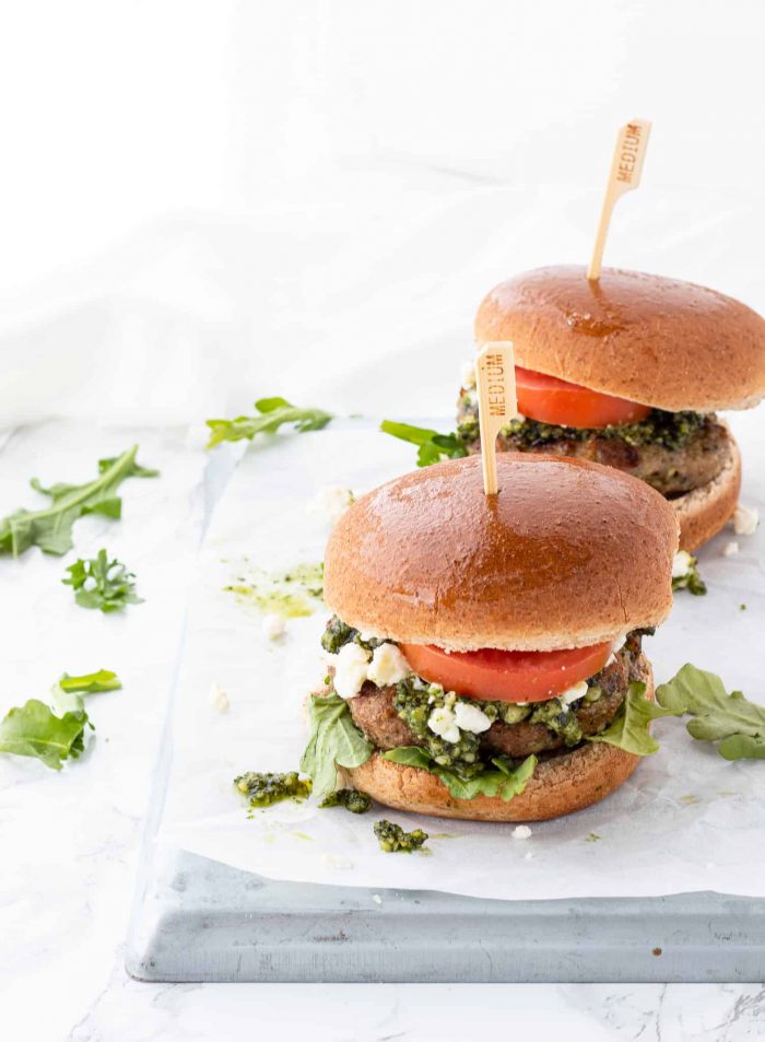 Two pesto chicken burgers served in buns