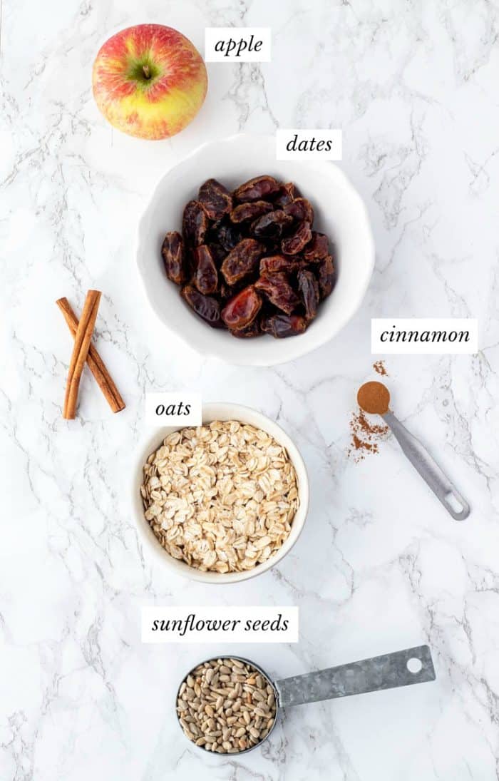 Ingredients for energy balls with labels on marble background
