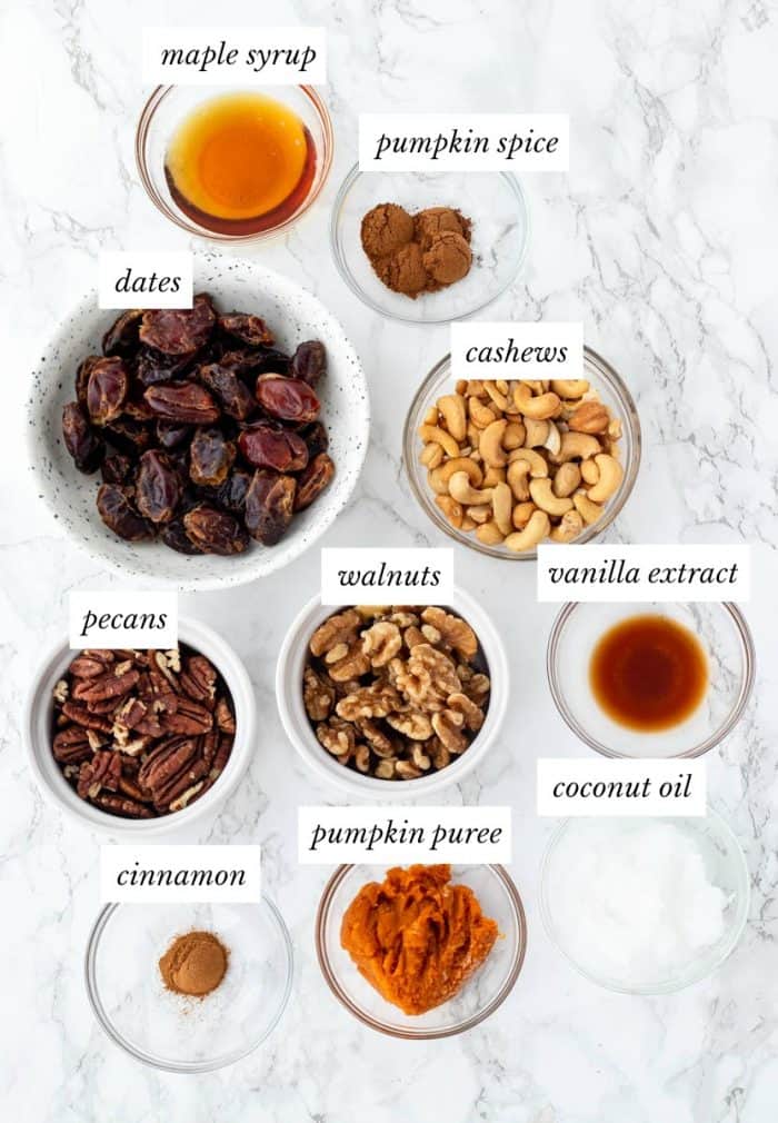 ingredients required for no bake pumpkin cheesecake on marble background with labels