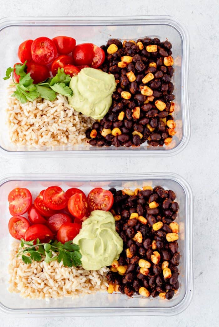 Black bean burrito bowls in two meal prep containers.