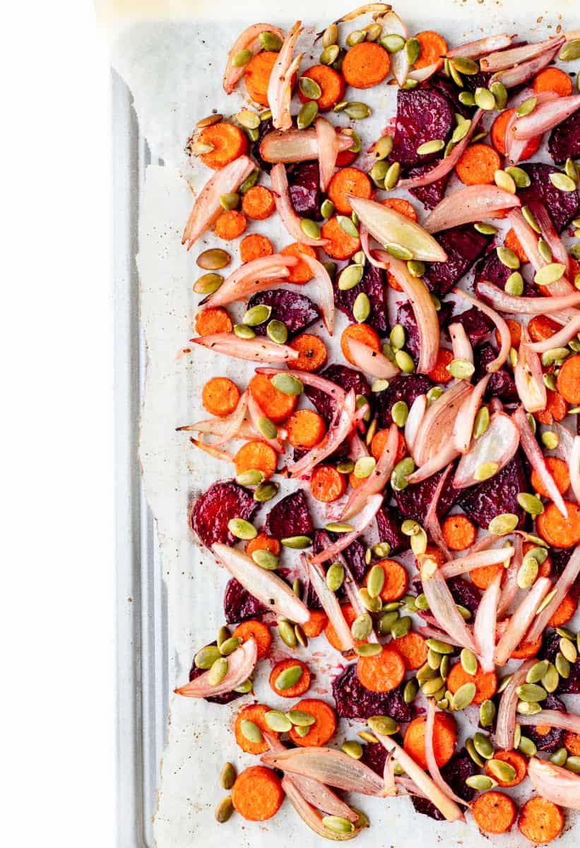 Roasted carrots and beets mixed with shallots and pumpkin seeds.