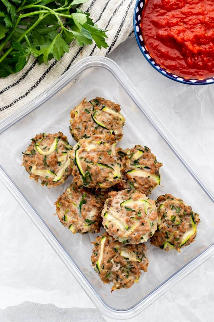 The chicken zucchini poppers in a storage container.