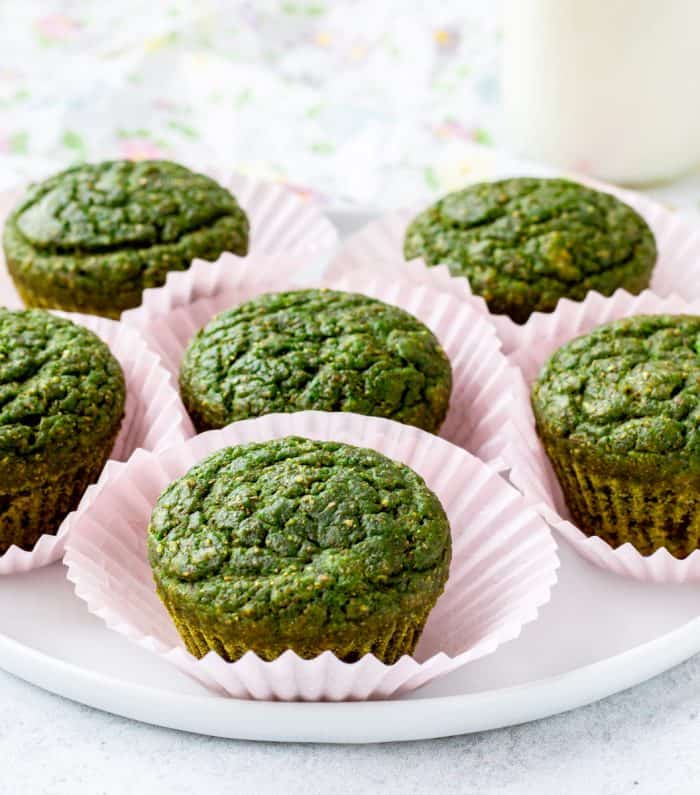 spinach muffins in pink paper liners on plate