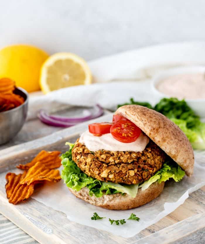 A chickpea burger with the top bun placed to one side.