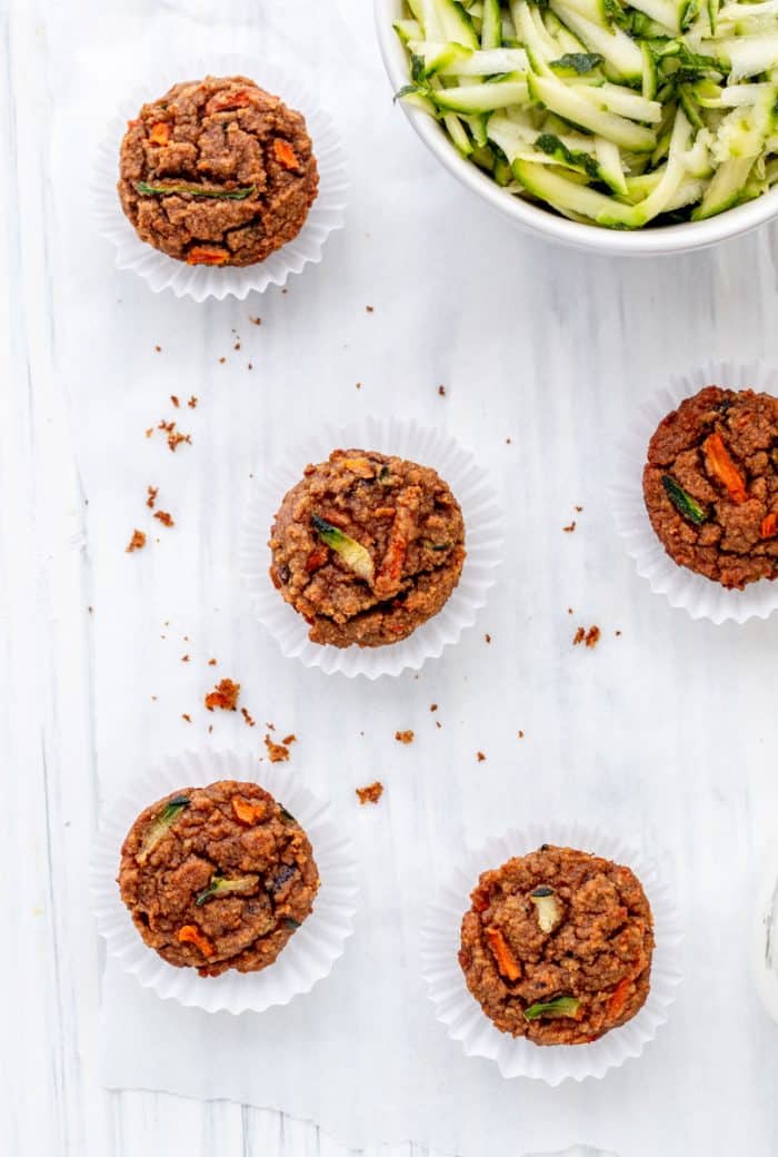 Overhead shot of four carrot zucchini muffins.