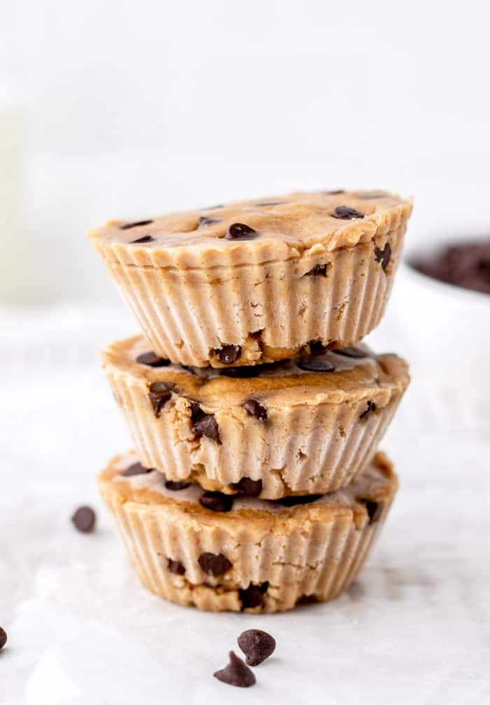 Three chocolate chip cookie dough bites stacked on top of each other.
