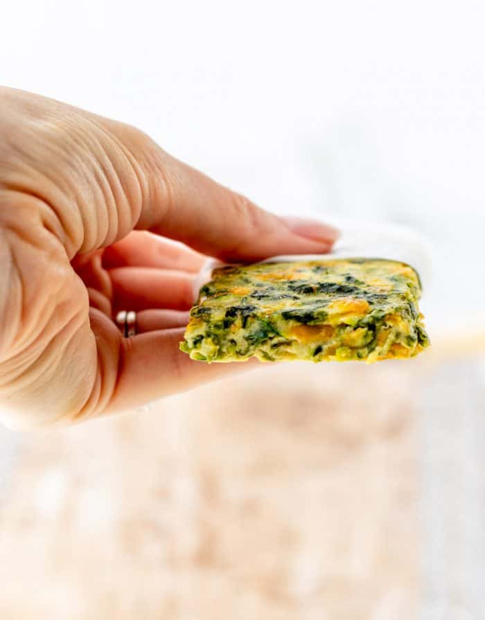 A hand holding a frittata finger.