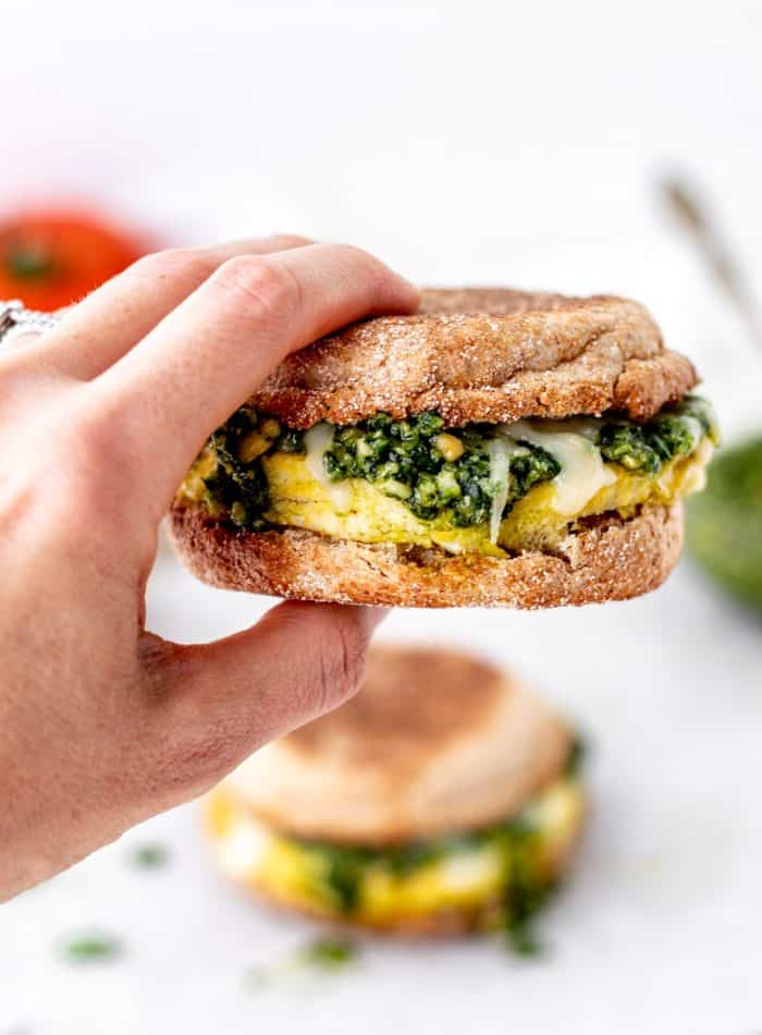 A hand holding a healthy breakfast sandwich.