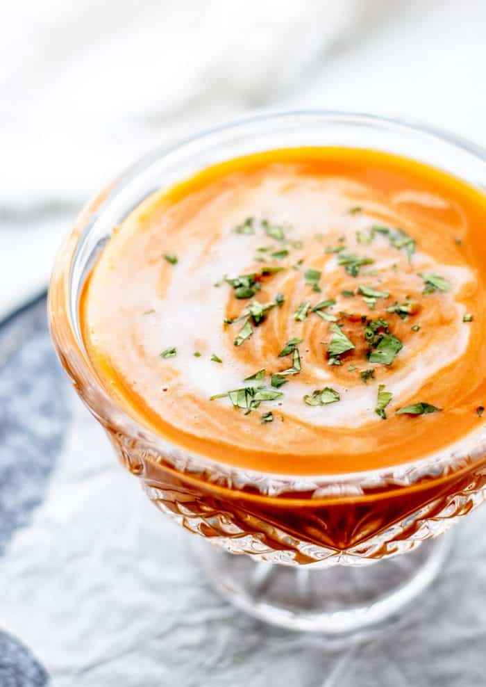 Pumpkin soup topped with coconut milk and fresh cilantro.