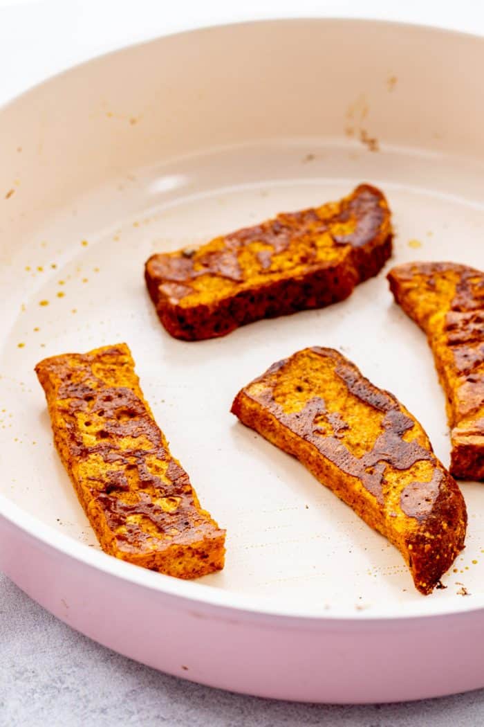 Close up of the pumpkin French toast sticks in a skillet.
