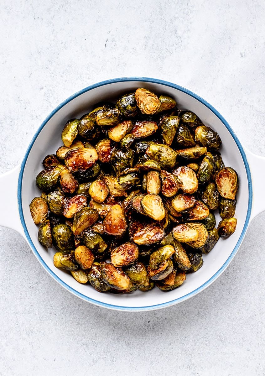roasted brussel sprouts in a white and blue bowl