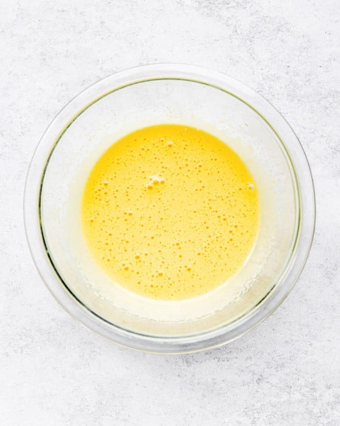 egg yolks whisked in a glass bowl