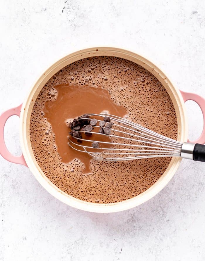 Whisking together the hot chocolate as it heats.