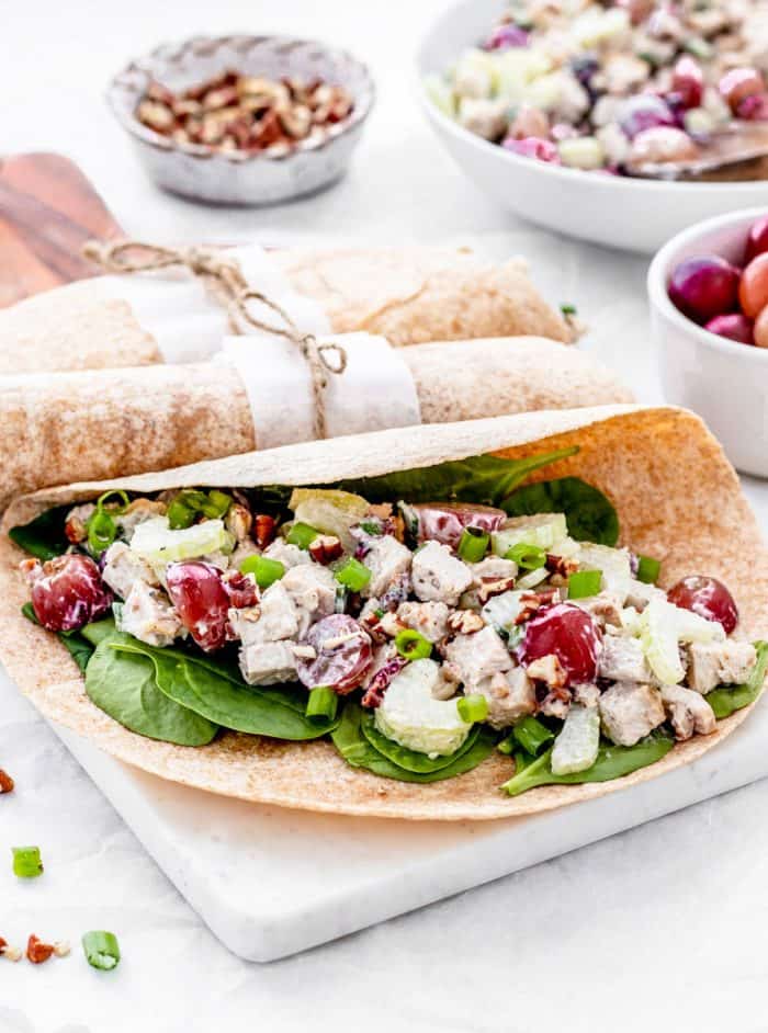 Spinach and turkey salad in a half closed wrap.