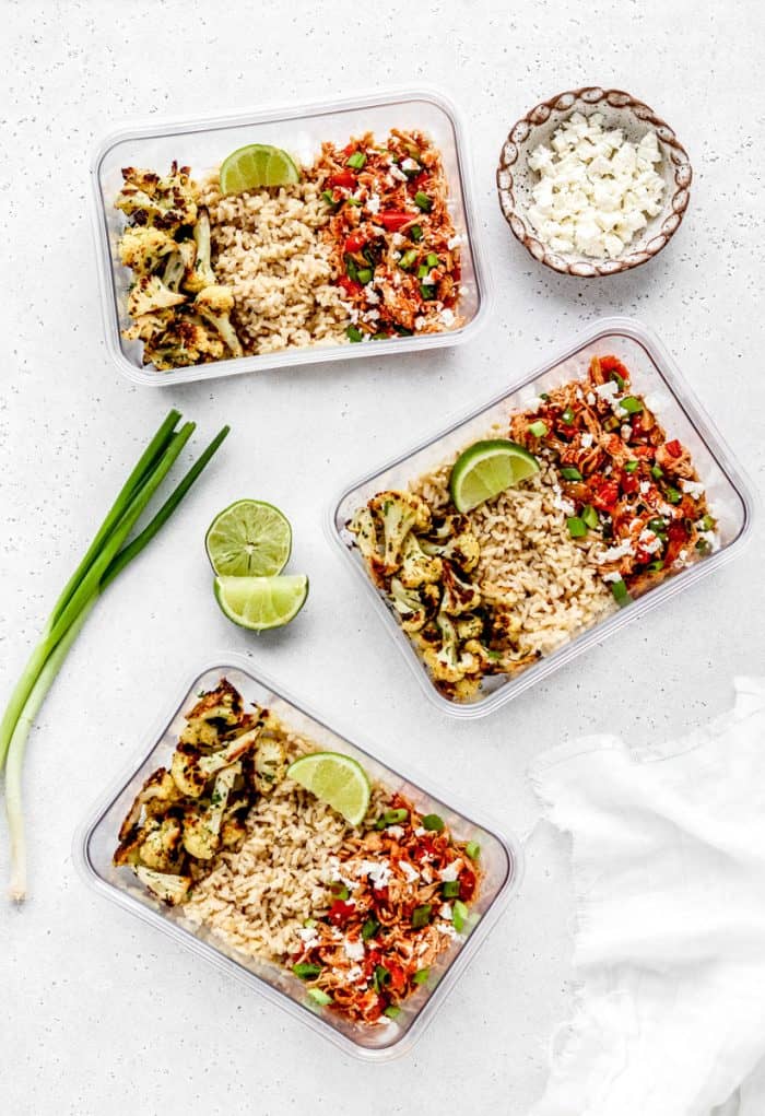 Three meal prep boxes with the buffalo chicken, rice and cauliflower.