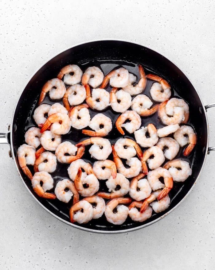 Cooking the shrimp in a skillet.