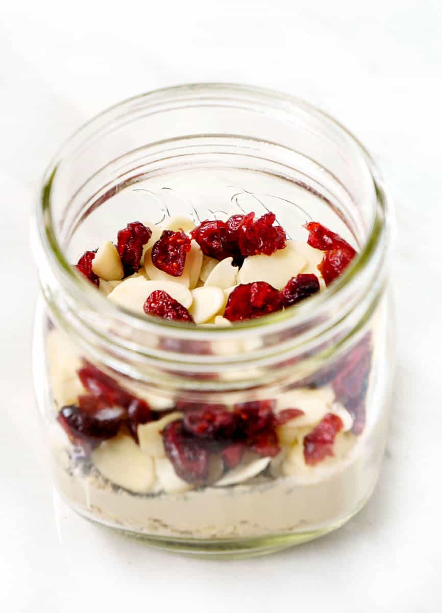 Side shot of cranberry almond overnight oats in mason jar.