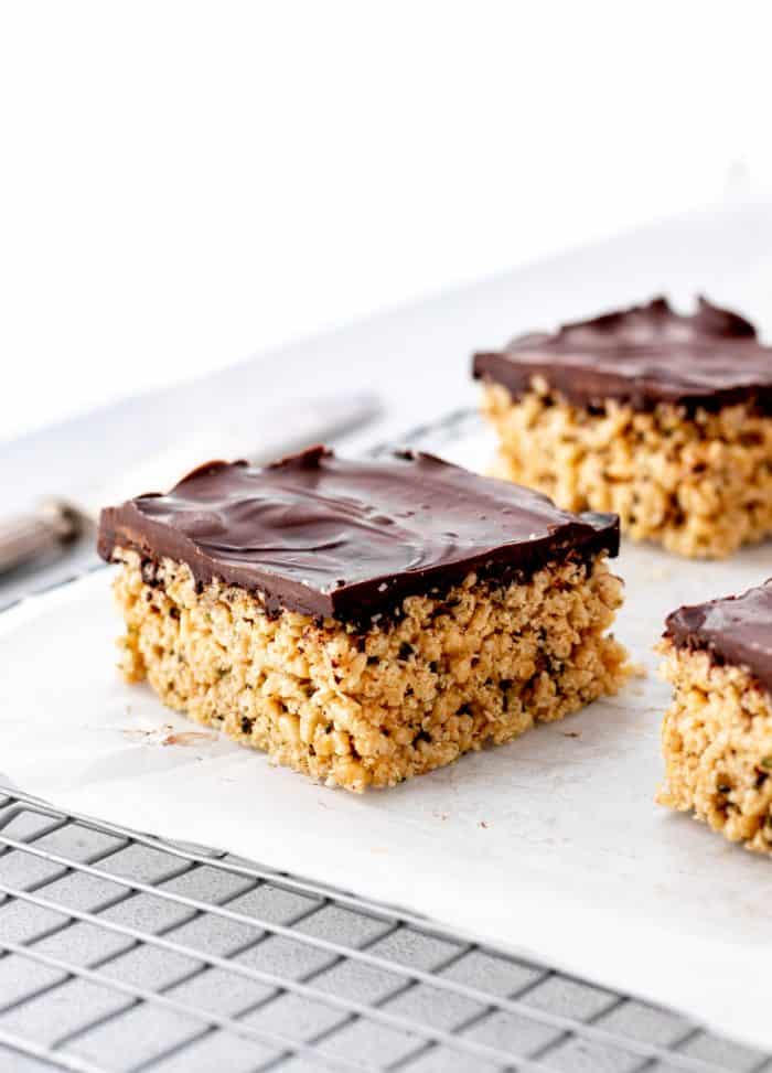A peanut butter rice crispy treat topped with a dark chocolate layer.