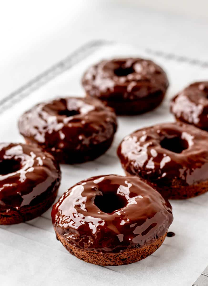 Baked donuts topped with a chocolate glaze.
