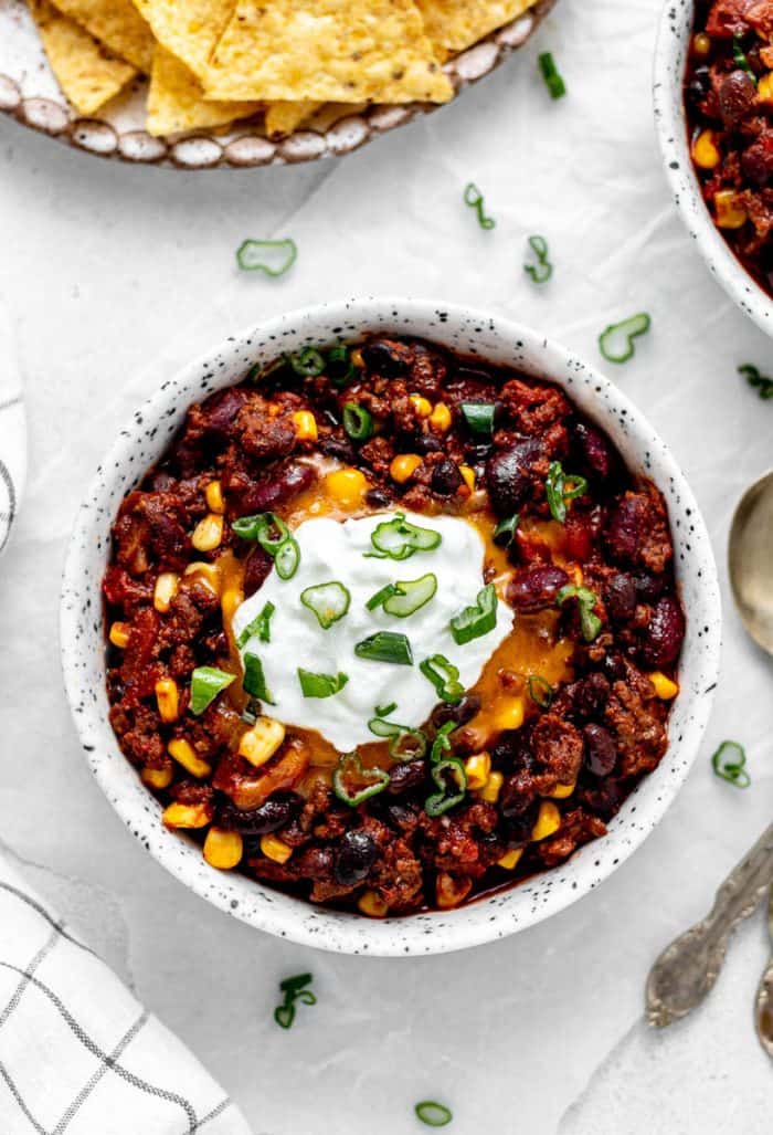 Beef chili in a bowl with toppings.