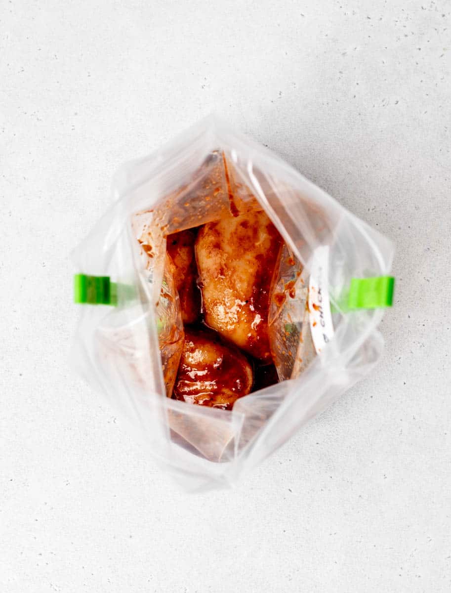 BBQ chicken marinade in a freezer bag on clips.