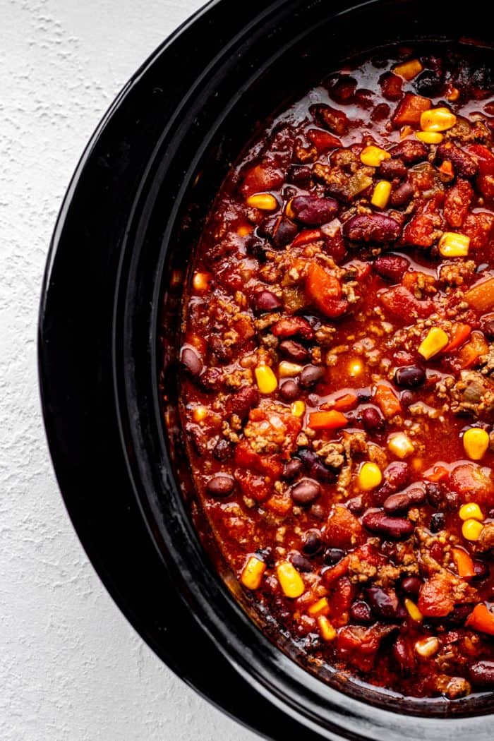 Chili with beans and corn in a slow cooker.