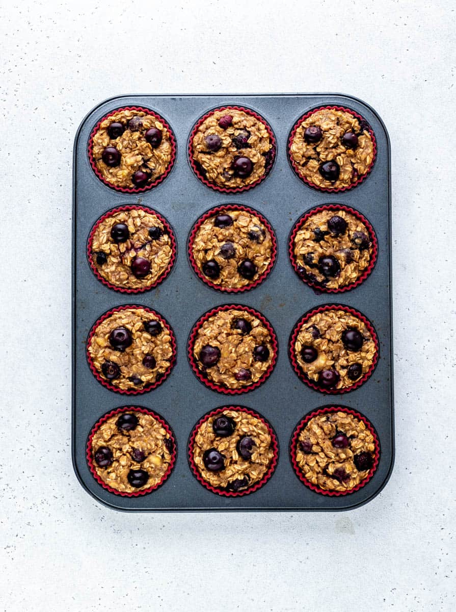 Baked blueberry banana oatmeal muffins in a tin.