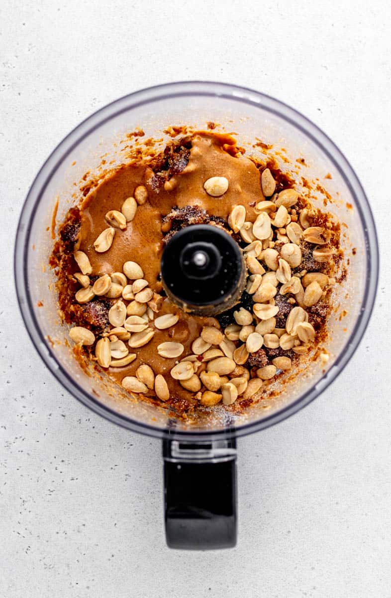 Peanuts and peanut butter added to the food processor.