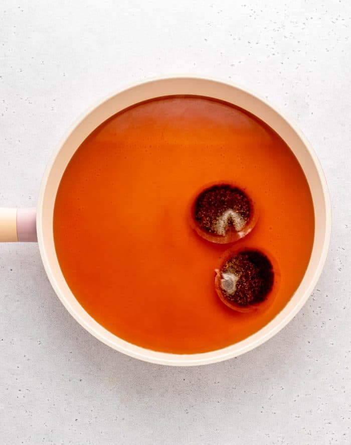 Rooibos tea bags with water in a large pot.