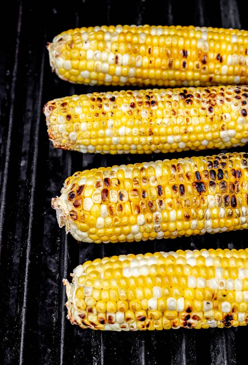 Ears of corn being grilled on the BBQ for the corn salad.