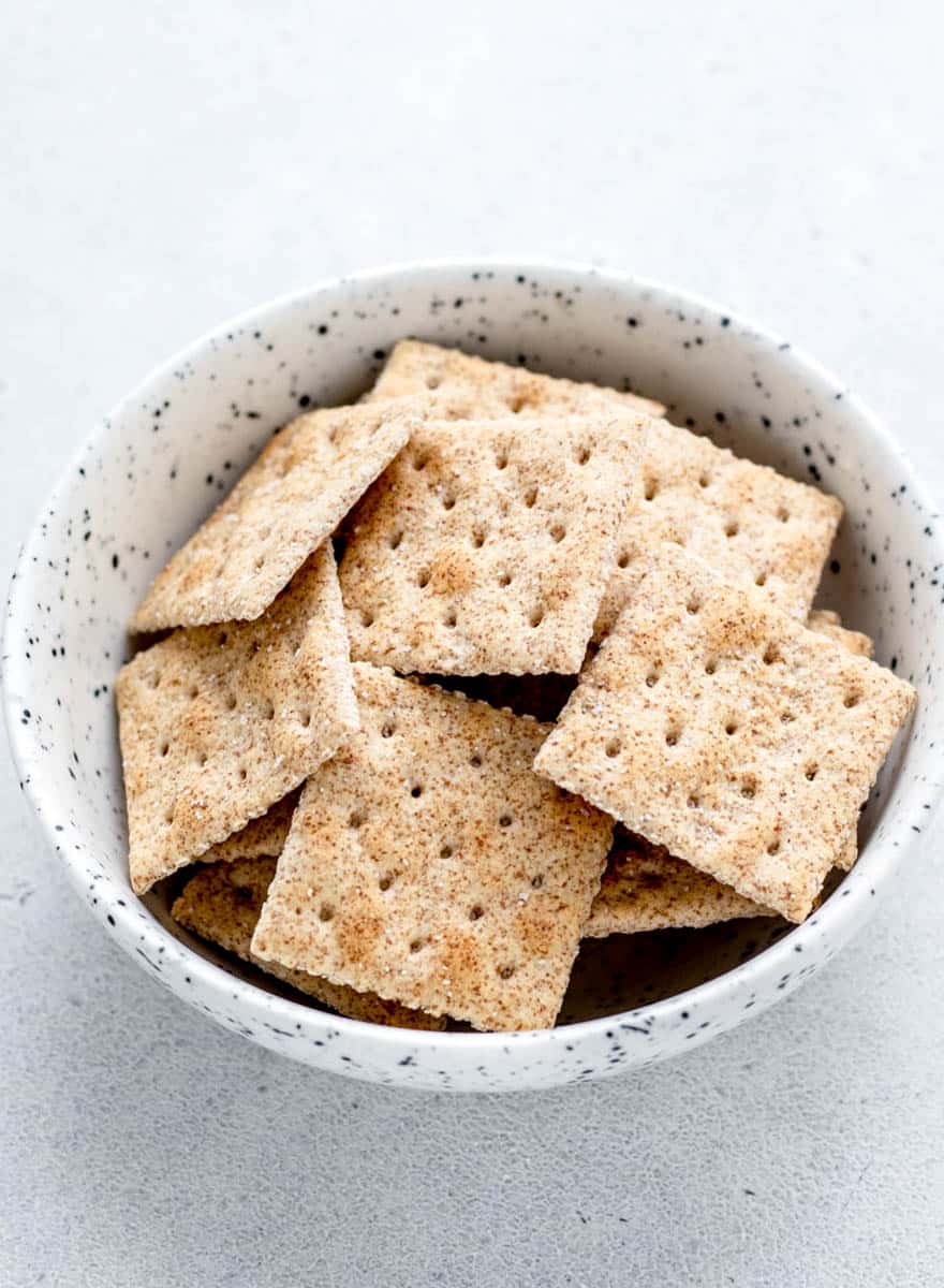 Whole-wheat saltine crackers in a small bowl.