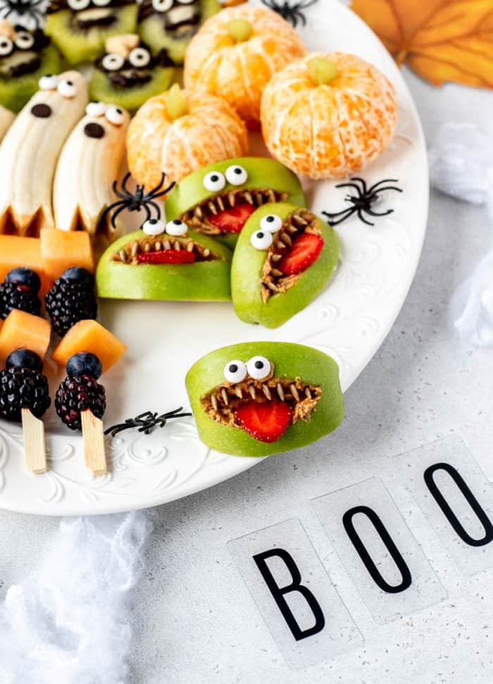 A Halloween fruit tray with a close up image of a Monster apple face.